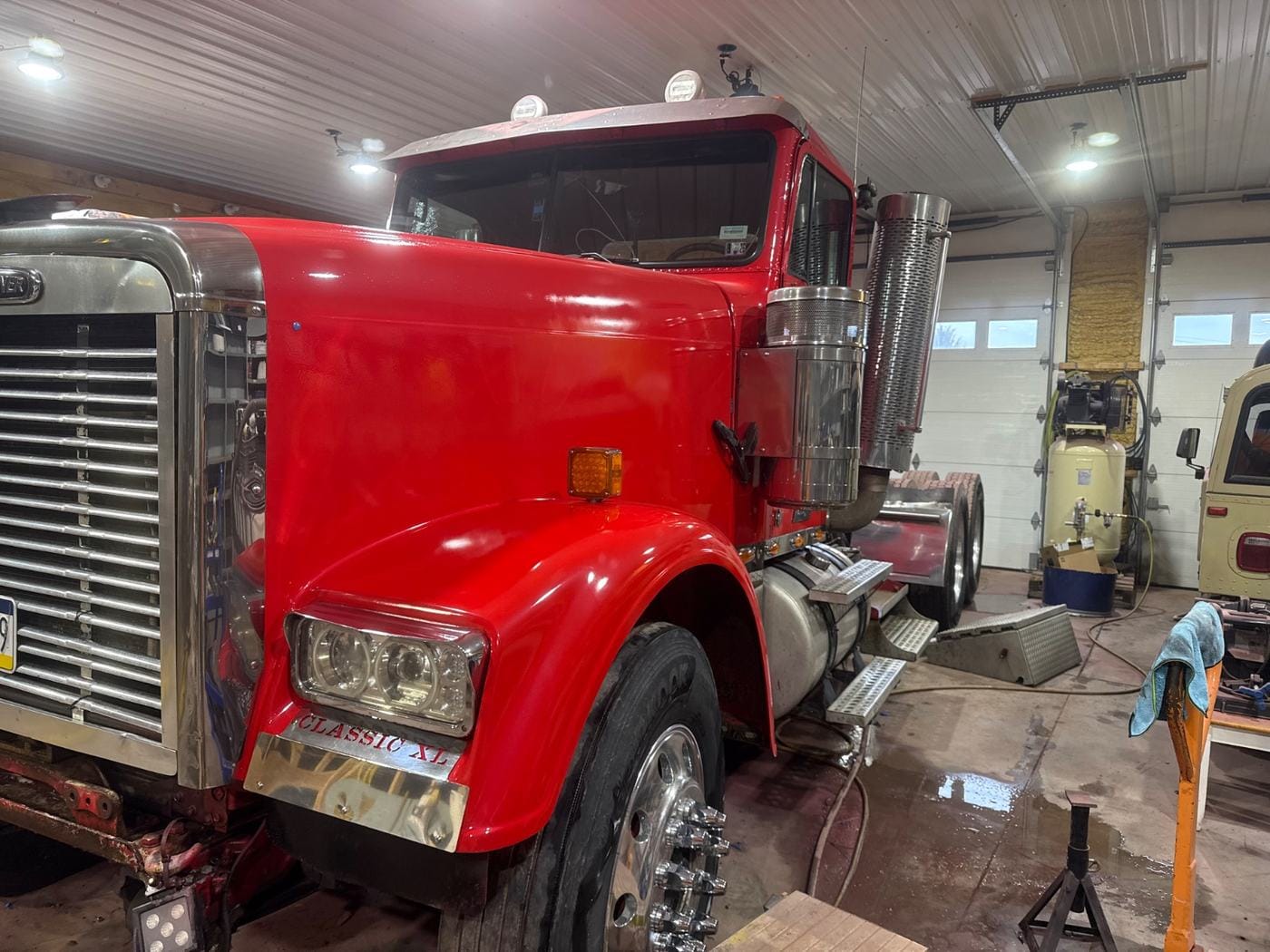 The front end of the red semi in the shop.