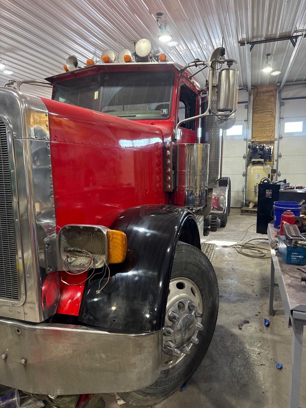 The red semi with a black fender in place.