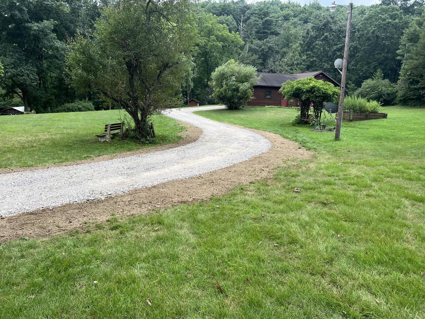 The same drive topped and edged, curving up to the house.