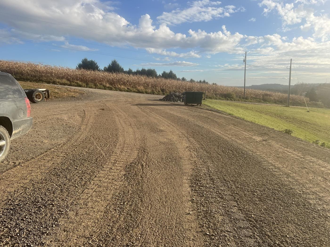 A wide graded area beside a cornfield.