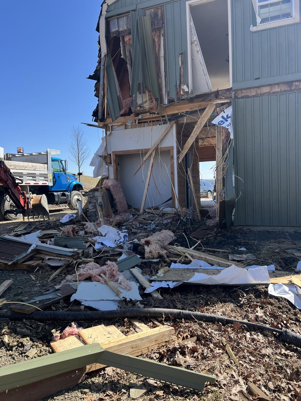 A two-story building opened up, with the dump truck standing by.