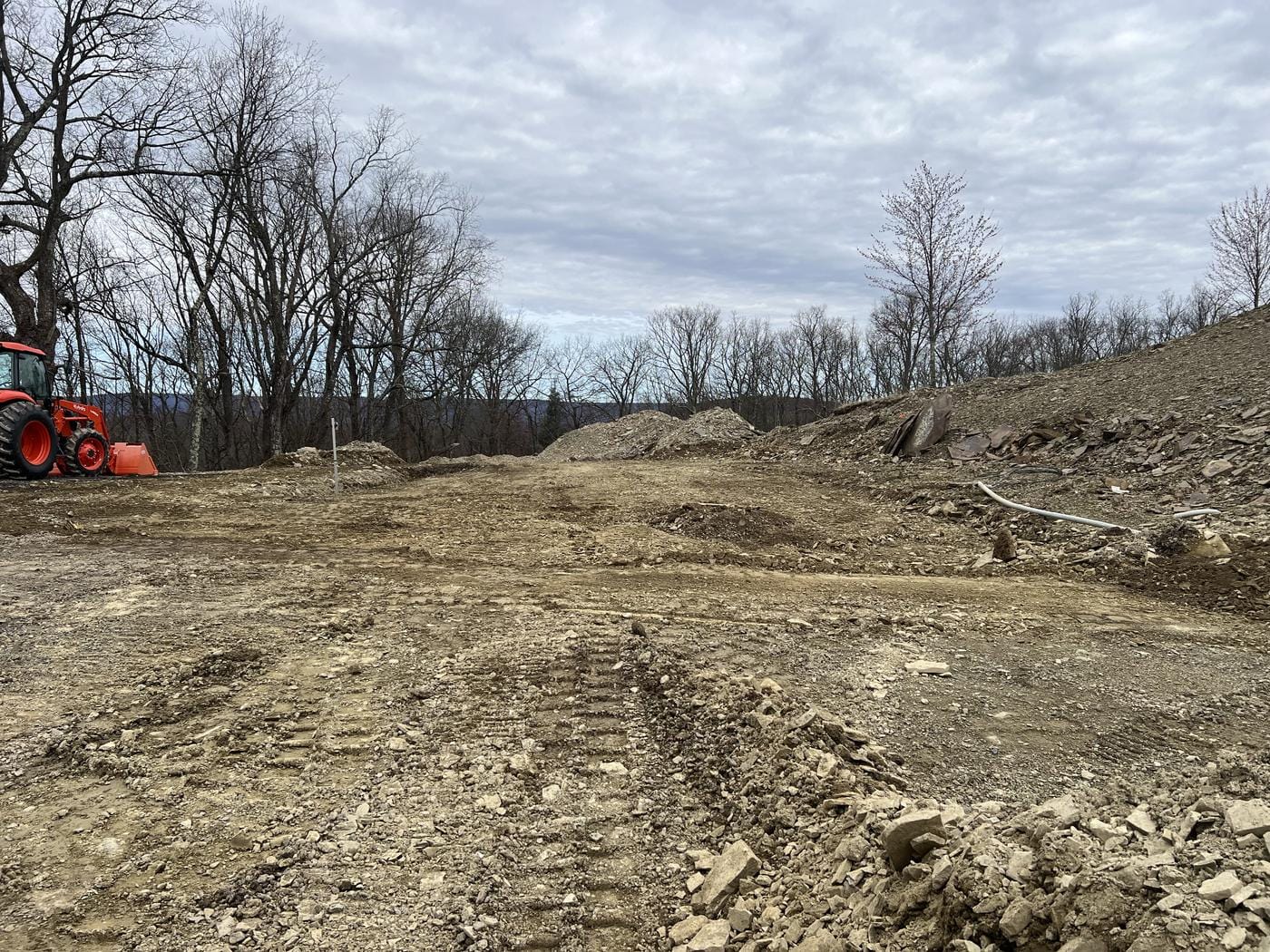 A building site rough-cut into the hillside.